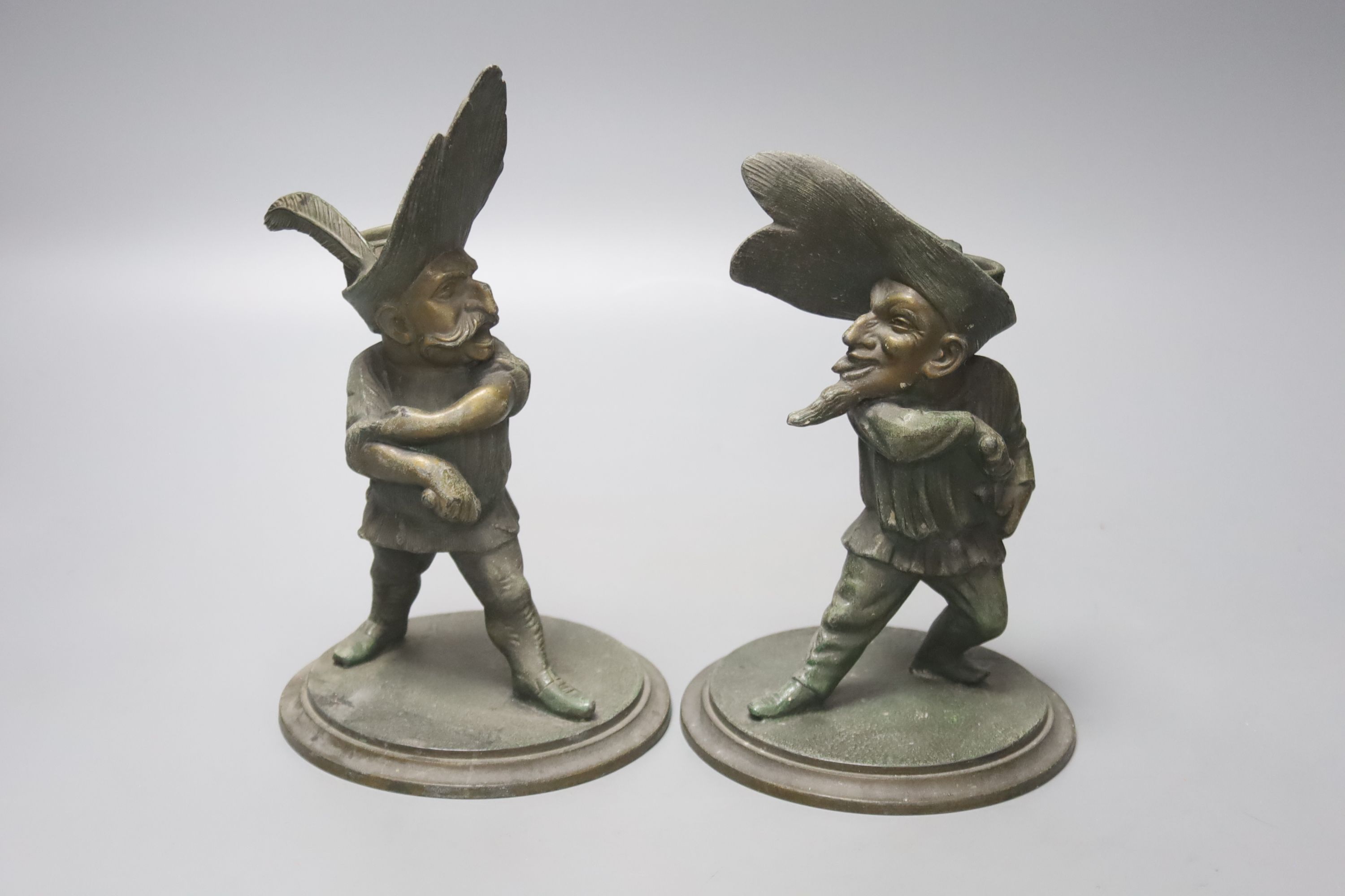 A pair of novelty duelling spelter figural candlesticks